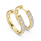 Roy Diamond yellow gold huggie hoop earrings close front angle with sparkling round diamonds on the outer edge
