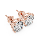 Rose gold earrings with clear Diamond on a white background