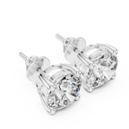 Pair of diamond stud earrings on a white background