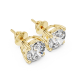 Gold stud earrings with clear gemstones on a white background