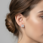 Close-up of a woman wearing square-shaped diamond earrings with a neutral background