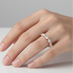 Hand wearing a diamond ring on a neutral background