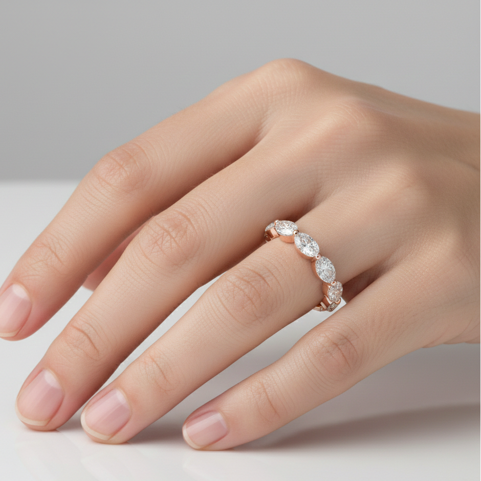 Hand wearing a diamond ring on a neutral background