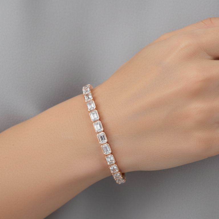 Hand wearing a diamond bracelet on a neutral background