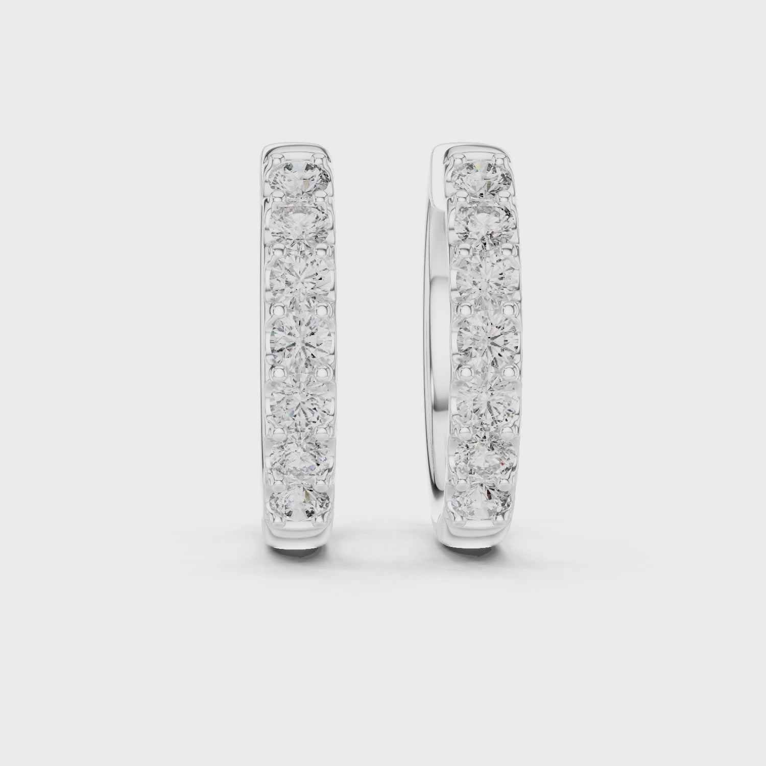360 rotating video of Roy Diamond white gold diamond huggie hoop earrings showing brilliant round diamonds