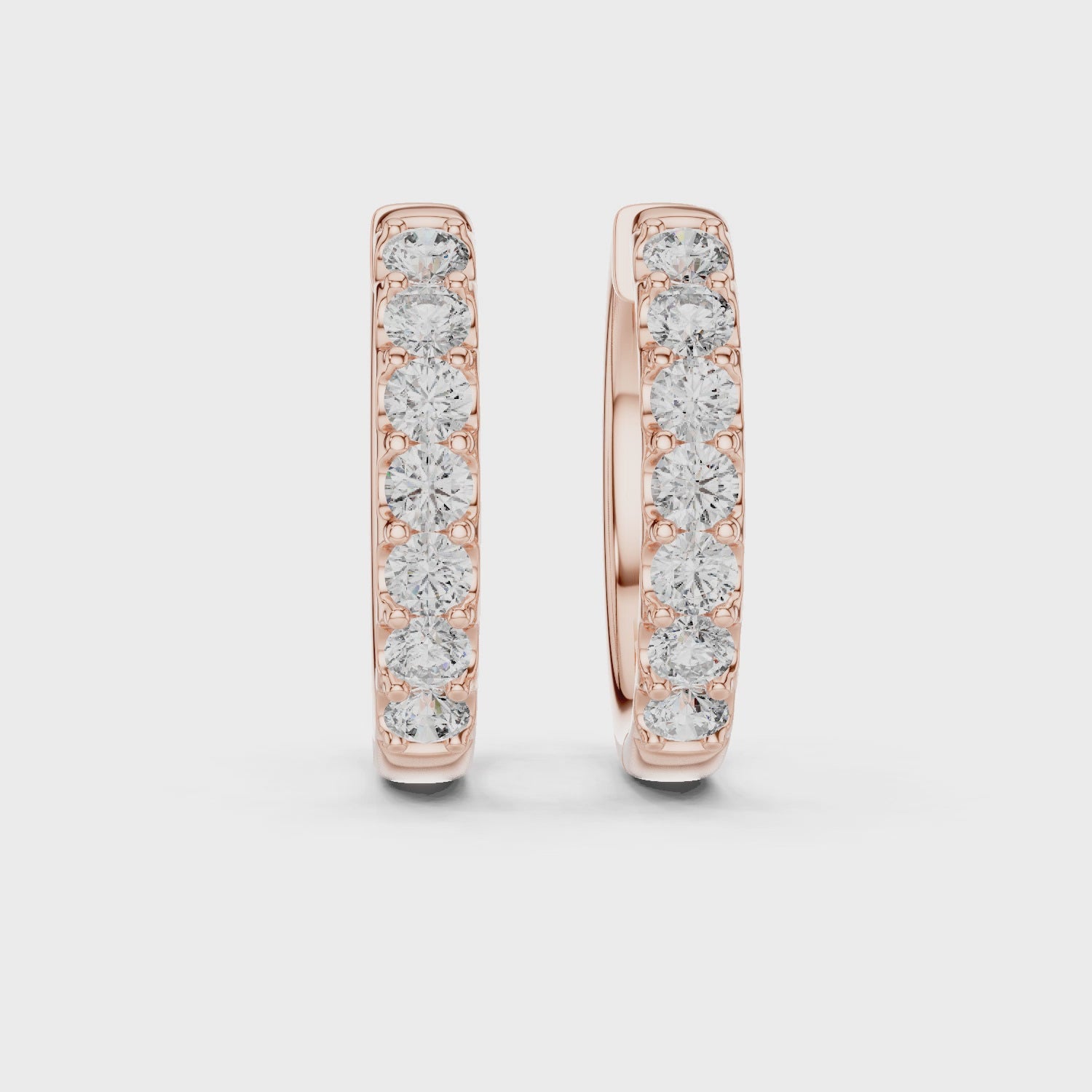 360 rotating video of Roy Diamond rose gold diamond huggie hoop earrings showing full sparkle and hinge clasp